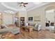 Spacious living room featuring hardwood floors, comfy seating, and a view into the Primary bedroom at 19718 Cobblestone Cir, Venice, FL 34292