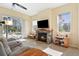 Living room features a fireplace and sliding doors to the pool area at 19718 Cobblestone Cir, Venice, FL 34292