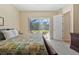 Main bedroom with sliding doors leading to a private patio and pool view at 19718 Cobblestone Cir, Venice, FL 34292