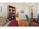Home office with hardwood floors and views of the en-suite bathroom at 19718 Cobblestone Cir, Venice, FL 34292
