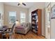 Home office with built-in bookcase and comfortable seating area at 19718 Cobblestone Cir, Venice, FL 34292