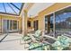 Spacious covered patio with comfortable seating and pool views at 19718 Cobblestone Cir, Venice, FL 34292