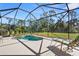 Relaxing screened-in pool and spa with lounge chairs at 19718 Cobblestone Cir, Venice, FL 34292