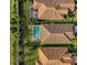 Aerial view showcasing home's tile roof and pool at 232 Benedetto Ct, Nokomis, FL 34275