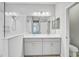 Modern bathroom with double vanity, large mirror, and walk-in shower at 232 Benedetto Ct, Nokomis, FL 34275