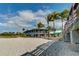 Beachfront restaurant with palm trees and seating at 232 Benedetto Ct, Nokomis, FL 34275