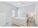 Bright bedroom with a double bed, nightstand, and dresser at 232 Benedetto Ct, Nokomis, FL 34275