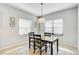 Cozy dining area with wooden table and gray chairs at 232 Benedetto Ct, Nokomis, FL 34275