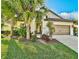Single-story home with a brown garage door and landscaped yard at 232 Benedetto Ct, Nokomis, FL 34275