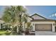 One-story house with palm trees and a brown garage door at 232 Benedetto Ct, Nokomis, FL 34275