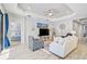 Bright living room featuring comfy seating and a large TV at 232 Benedetto Ct, Nokomis, FL 34275
