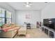 Cozy living room features a comfortable sofa, a desk, and a large TV at 232 Benedetto Ct, Nokomis, FL 34275
