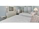 Guest bedroom with two twin beds, dresser, and ocean view at 255 The Esplanade N # 603, Venice, FL 34285