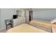 Guest bedroom with two twin beds and dresser, near bathroom at 255 The Esplanade N # 603, Venice, FL 34285