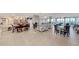Spacious community room with tables, chairs, and a large bookcase at 255 The Esplanade N # 603, Venice, FL 34285