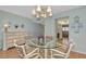 Elegant dining room featuring a glass table and chandelier at 255 The Esplanade N # 603, Venice, FL 34285