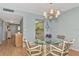 Bright dining room with glass-top table and four chairs at 255 The Esplanade N # 603, Venice, FL 34285