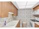 Small condo kitchen with white appliances and wood cabinets at 255 The Esplanade N # 603, Venice, FL 34285