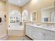 Bathroom boasts double vanity, a soaking tub, and a walk-in shower at 305 Rio Terra, Venice, FL 34285