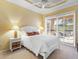 Bright bedroom with white furniture and sliding glass doors at 305 Rio Terra, Venice, FL 34285