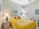 Cozy bedroom with a yellow comforter and white nightstands at 305 Rio Terra, Venice, FL 34285