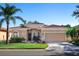 Attractive single-story home with a tile roof and landscaped front yard at 305 Rio Terra, Venice, FL 34285