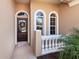 Inviting front entry with decorative door and sidelights at 305 Rio Terra, Venice, FL 34285