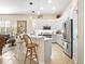 Modern kitchen with white cabinetry, stainless steel appliances, and a breakfast bar area at 305 Rio Terra, Venice, FL 34285