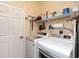 Well-organized laundry room featuring a modern washer and dryer, shelving, and storage space at 305 Rio Terra, Venice, FL 34285