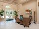 Elegant lobby with soaring ceilings, bright light from glass doors, comfortable seating and colorful painting at 305 Rio Terra, Venice, FL 34285
