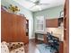 Home office with wood desk, built-in shelving, and comfortable chair at 305 Rio Terra, Venice, FL 34285