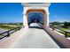 Modern pedestrian bridge with arched entryway, offering scenic views of surroundings at 305 Rio Terra, Venice, FL 34285