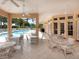 Relaxing pool area with tables and chairs for residents at 305 Rio Terra, Venice, FL 34285