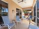 Relaxing screened porch with patio furniture and ceiling fan at 305 Rio Terra, Venice, FL 34285