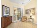 Bright sitting room with sliding glass doors, decorative chest, and a cozy armchair at 305 Rio Terra, Venice, FL 34285