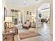 Inviting sitting room with comfortable wicker furniture, neutral tones, and sliding glass doors at 305 Rio Terra, Venice, FL 34285