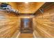 Walk-in closet with wooden shelving and a dresser at 4 Dover Dr, Englewood, FL 34223