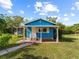 Front view of a small blue house with a covered porch at 4533 Church St, Punta Gorda, FL 33980