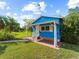 Front view of a small blue house with a covered porch at 4533 Church St, Punta Gorda, FL 33980