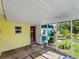 Bright yellow screened porch with access to the backyard at 4533 Church St, Punta Gorda, FL 33980