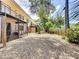 Fenced backyard with gravel and tropical landscaping at 509 Parkdale Mews # 509, Venice, FL 34285