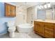 Bathroom featuring tub-shower combo, oak vanity, updated fixtures, and ample storage at 509 Parkdale Mews # 509, Venice, FL 34285