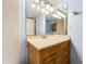 Clean bathroom with wood vanity and tiled walls at 509 Parkdale Mews # 509, Venice, FL 34285