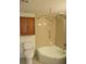 Bathroom showing tub-shower combination with tiled walls, toilet and cabinetry for storage at 509 Parkdale Mews # 509, Venice, FL 34285