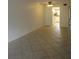 An open-concept living room leads to the kitchen with tiled floors and neutral walls creating a blank canvas at 509 Parkdale Mews # 509, Venice, FL 34285
