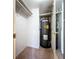 Compact utility room with a water heater, shelving, and neutral walls and carpet at 509 Parkdale Mews # 509, Venice, FL 34285