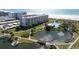 Oceanfront condo building with pool, pond, and lush landscaping at 5790 Midnight Pass Rd # 602, Sarasota, FL 34242