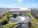 Aerial view of coastal community with pool, pond, and beach access at 5790 Midnight Pass Rd # 602, Sarasota, FL 34242