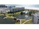Luxury condo building near beach with pond and walkway at 5790 Midnight Pass Rd # 602, Sarasota, FL 34242