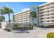 Modern condo building with ample parking and tropical landscaping at 5790 Midnight Pass Rd # 602, Sarasota, FL 34242